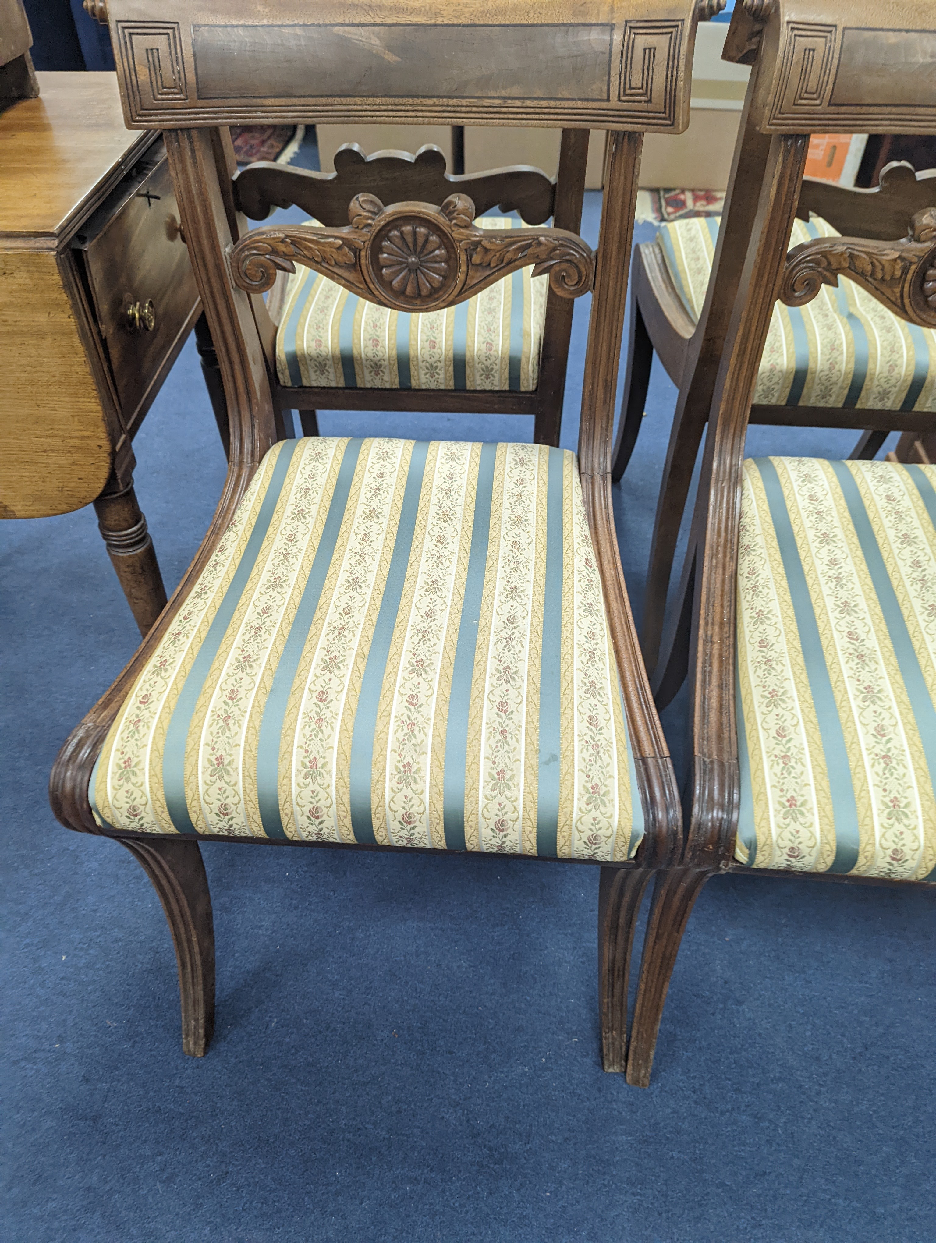 A set of six Regency mahogany dining chairs on sabre legs